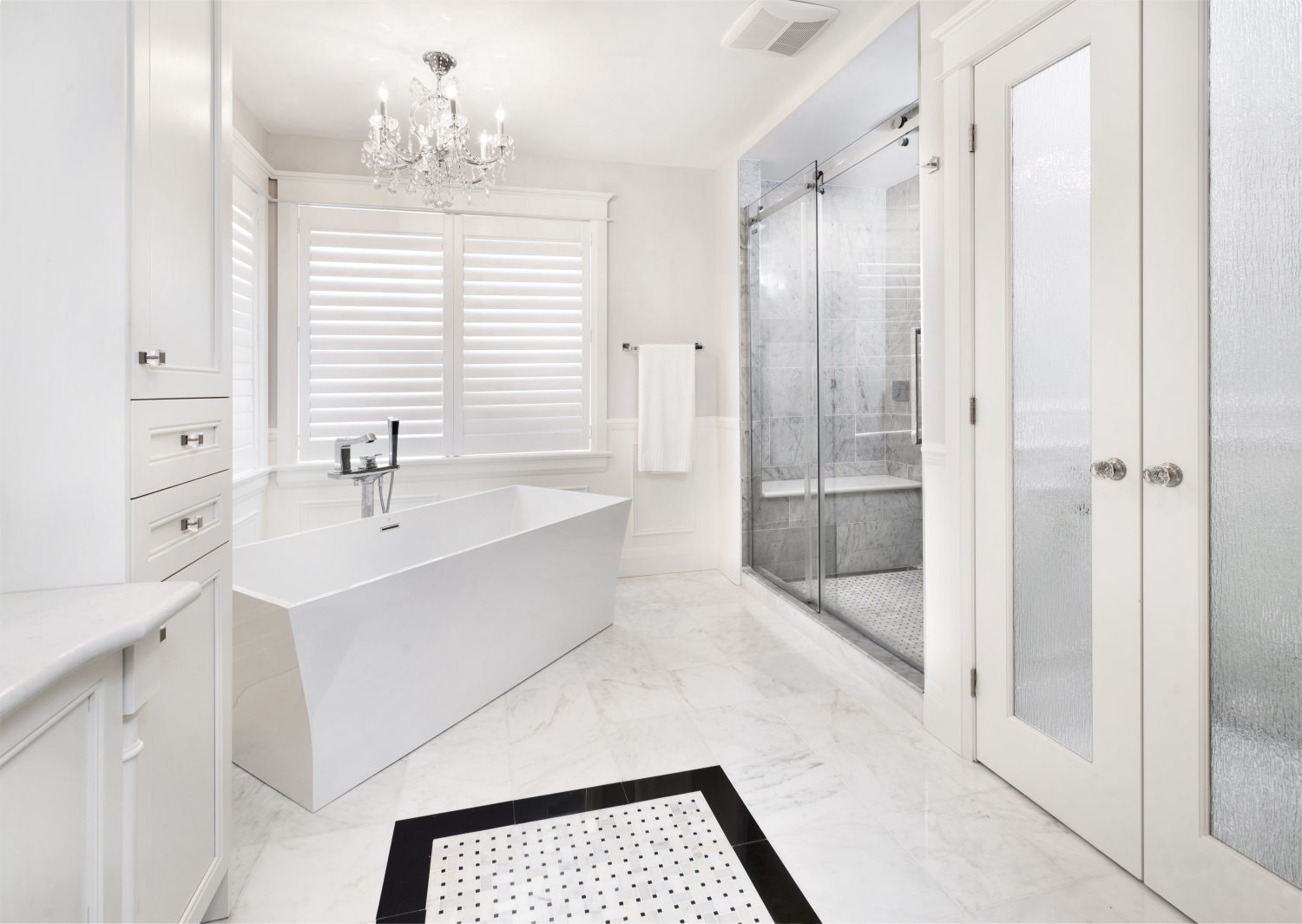 Photo of a modern white bathroom with large tub